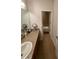 Bathroom with granite countertop, tiled floor, and bathtub at 4210 Pacente Loop, Zephyrhills, FL 33543