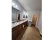 Bright bathroom featuring a double vanity, tile flooring and ample counter space at 4210 Pacente Loop, Zephyrhills, FL 33543