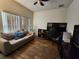 Cozy bedroom with a large window, desk, and comfortable sofa at 4210 Pacente Loop, Zephyrhills, FL 33543