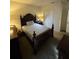 Bedroom featuring a large bed and a bedside table with lamp at 4210 Pacente Loop, Zephyrhills, FL 33543