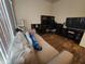 Bright bedroom featuring a comfortable sofa and a corner desk at 4210 Pacente Loop, Zephyrhills, FL 33543
