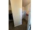 Walk-in closet with two rows of hanging racks and storage space for clothing and personal items at 4210 Pacente Loop, Zephyrhills, FL 33543