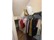 Walk-in closet with hanging clothes and shelves, providing ample storage space in the home at 4210 Pacente Loop, Zephyrhills, FL 33543