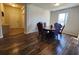 Bright dining room with wood floors and a decorative round table at 4210 Pacente Loop, Zephyrhills, FL 33543