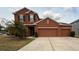 Charming two-story home with a three car garage and well manicured lawn at 4210 Pacente Loop, Zephyrhills, FL 33543