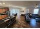 Open concept living room and kitchen with modern stainless steel appliances at 4210 Pacente Loop, Zephyrhills, FL 33543