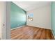 Bright bedroom showcasing wood-look floors, fresh paint, and a window view at 4215 La Sorrento Ct, Tampa, FL 33611