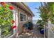 Charming back patio with tropical landscaping and a view of the water in the background at 447 22Nd St, Belleair Beach, FL 33786