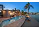 Backyard pool and waterfront views at dusk at 447 22Nd St, Belleair Beach, FL 33786