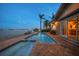 Backyard pool and spa with waterfront views at dusk at 447 22Nd St, Belleair Beach, FL 33786