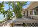 A charming backyard deck and landscaping offer a peaceful outdoor escape with scenic waterfront vistas at 447 22Nd St, Belleair Beach, FL 33786