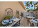 Charming outdoor patio with seating, unique decor, and lush greenery, perfect for relaxing or entertaining at 447 22Nd St, Belleair Beach, FL 33786
