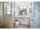 Bathroom with a shower featuring glass doors and white cabinets at 447 22Nd St, Belleair Beach, FL 33786