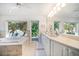 Bathroom with tub, garden view, and double vanity with cabinets at 447 22Nd St, Belleair Beach, FL 33786