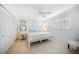 Bright bedroom featuring a ceiling fan, closet, tile floors, and a calming color scheme at 447 22Nd St, Belleair Beach, FL 33786