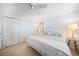 Bright bedroom featuring a ceiling fan, closet, tile floors, and a calming color scheme at 447 22Nd St, Belleair Beach, FL 33786