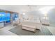 A bright bedroom with a ceiling fan, accent rug, and water view at 447 22Nd St, Belleair Beach, FL 33786