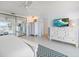 Bright bedroom features tile floor, ceiling fan, and mirrored closet with water view at 447 22Nd St, Belleair Beach, FL 33786
