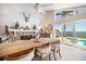 Charming dining room overlooking the pool and water, featuring a stone fireplace and ample natural light at 447 22Nd St, Belleair Beach, FL 33786