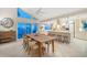 Bright dining room showcasing large windows with waterfront views and a wooden dining table at 447 22Nd St, Belleair Beach, FL 33786