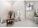 Bright foyer with tiled floor, high ceilings, and an elegant chandelier at 447 22Nd St, Belleair Beach, FL 33786