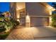 Well-lit home front showcasing the entrance, garage, and landscaped walkway at 447 22Nd St, Belleair Beach, FL 33786