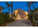 Home featuring mature landscaping, driveway, and garage at 447 22Nd St, Belleair Beach, FL 33786