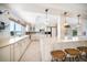 Bright kitchen featuring an island with barstool seating and ample counter space at 447 22Nd St, Belleair Beach, FL 33786