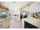 Bright kitchen with white cabinets and island, offering access to the living area at 447 22Nd St, Belleair Beach, FL 33786