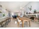Open-concept living space featuring stone fireplace, dining area and multiple seating areas at 447 22Nd St, Belleair Beach, FL 33786