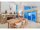 Living area with fireplace, dining table, and a view of waterfront through large windows at 447 22Nd St, Belleair Beach, FL 33786
