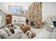 Spacious living room features a stone fireplace, vaulted ceilings, and views of the water at 447 22Nd St, Belleair Beach, FL 33786