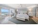 Serene bedroom with waterfront views, featuring white furnishings and a chevron patterned rug at 447 22Nd St, Belleair Beach, FL 33786