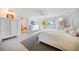 Inviting bedroom with water views, features a closet with access to the bathroom with glass blocks at 447 22Nd St, Belleair Beach, FL 33786