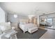 Bright bedroom with mirrored closet doors and water views, features white furnishings and decor at 447 22Nd St, Belleair Beach, FL 33786