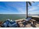 Waterfront patio lounge area featuring comfortable seating and serene views of the beautiful water at 447 22Nd St, Belleair Beach, FL 33786