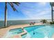 A waterfront pool and hot tub provides the perfect spot to enjoy stunning views of the bay at 447 22Nd St, Belleair Beach, FL 33786