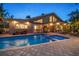 Back of home showcasing a large, inviting pool and spa with tile surround at 447 22Nd St, Belleair Beach, FL 33786