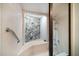 Unique shower with a stone wall feature, grab bar, and tile surround at 447 22Nd St, Belleair Beach, FL 33786