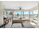 Bright sunroom with large windows, tiled floor, and stunning water views at 447 22Nd St, Belleair Beach, FL 33786