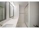 Modern bathroom featuring dual sinks, quartz countertops, and a glass-enclosed shower at 4511 S Manhattan Ave # 18, Tampa, FL 33611