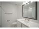 Bathroom featuring a framed mirror, drawers, toilet, brushed nickel fixtures, and a tiled shower at 4511 S Manhattan Ave # 18, Tampa, FL 33611