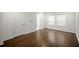 Spacious bedroom with hardwood floors, white trim, and natural light from a double window at 4511 S Manhattan Ave # 18, Tampa, FL 33611
