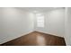Cozy bedroom with dark wood flooring and a window offering natural light at 4511 S Manhattan Ave # 18, Tampa, FL 33611