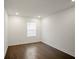 Bedroom with dark wood flooring, a window, and a fresh, neutral color scheme at 4511 S Manhattan Ave # 18, Tampa, FL 33611