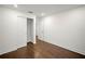 Bedroom boasting dark wood flooring, a walk-in closet, and a minimalist aesthetic at 4511 S Manhattan Ave # 18, Tampa, FL 33611