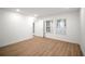 Bright bedroom with wood-look flooring and abundant natural light from two windows at 4511 S Manhattan Ave # 18, Tampa, FL 33611