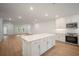 Open-concept kitchen with island, stainless appliances, and ample storage, seamlessly connecting to the living area at 4511 S Manhattan Ave # 18, Tampa, FL 33611