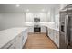 Open kitchen features an island, recessed lighting, stainless appliances, and light wood floors at 4511 S Manhattan Ave # 18, Tampa, FL 33611