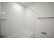 All-white shower and tub with subway tile surround, brushed nickel fixtures, and glass shelf at 4511 S Manhattan Ave # 18, Tampa, FL 33611